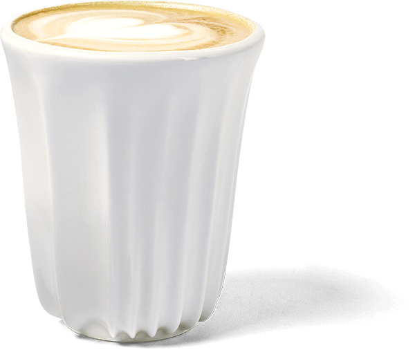 A white ceramic cup of cappuccino with a heart-shaped design on the foam