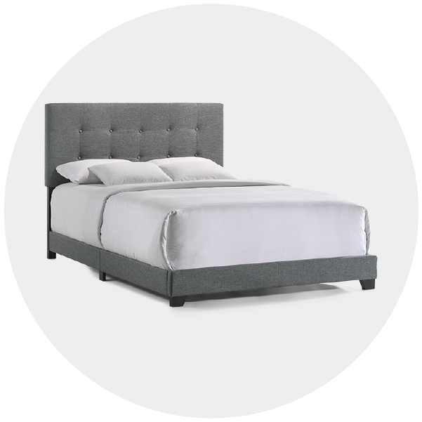 Gray upholstered bed with tufted headboard and white bedding