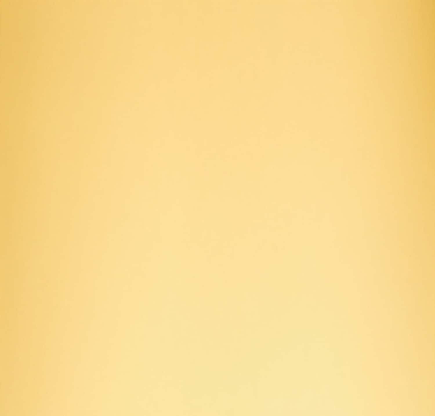 A close-up of a smooth, pale yellow wall with a subtle gradient