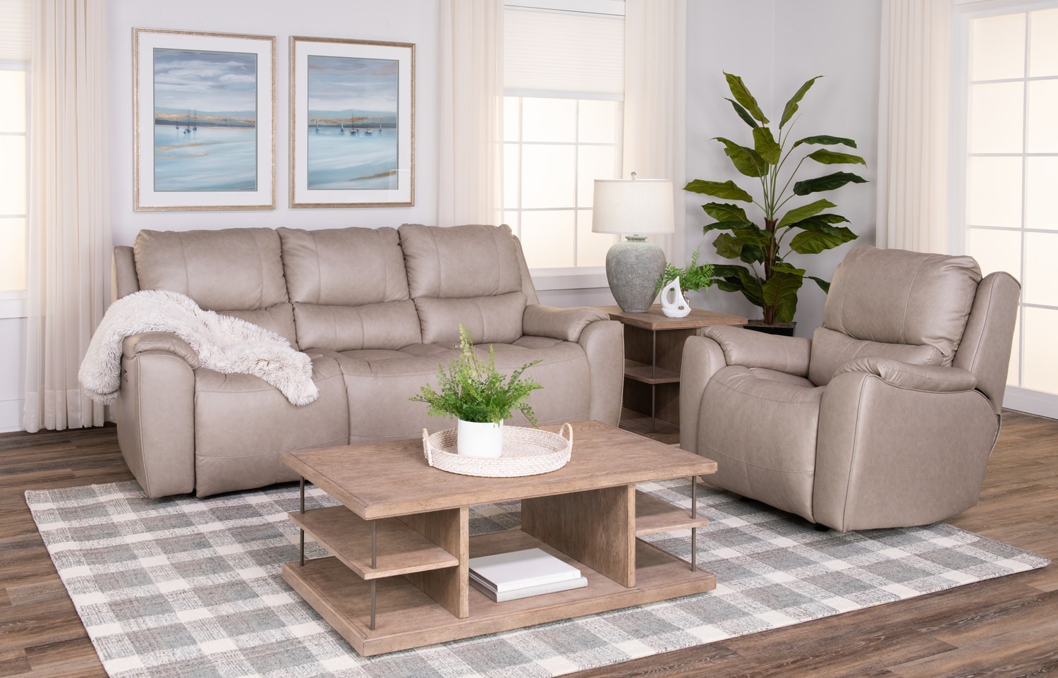 Modern living room with a beige sofa set, coffee table, and houseplants