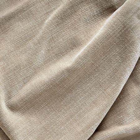 Close-up of a textured beige fabric with soft folds