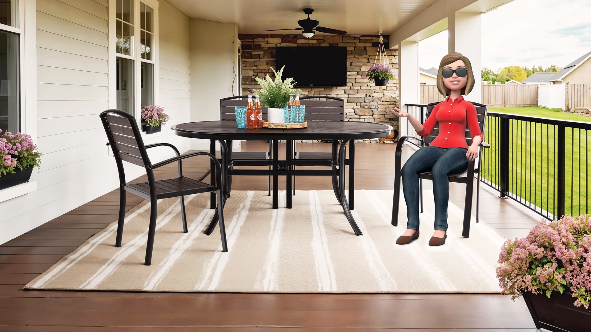 Ali sitting at a patio table on a deck with plants and outdoor fireplace