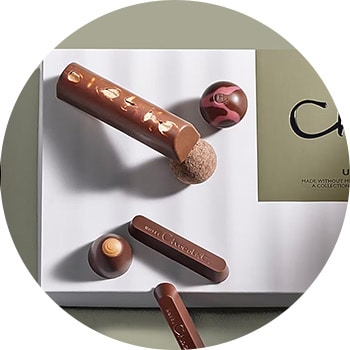 Assorted makeup products and brushes on a geometric background