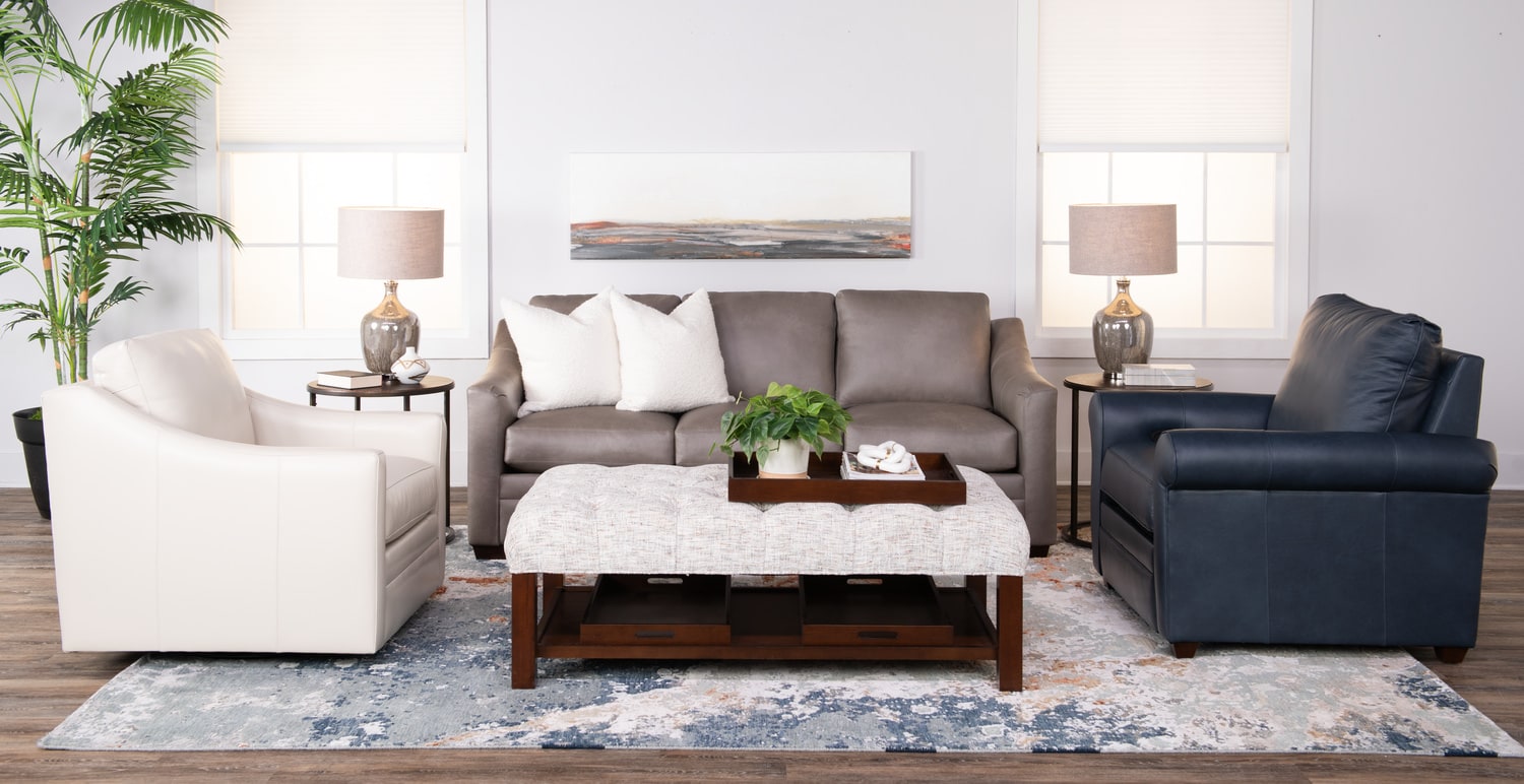 Modern living room with a sofa set and wooden coffee table, decorated with plants and paintings
