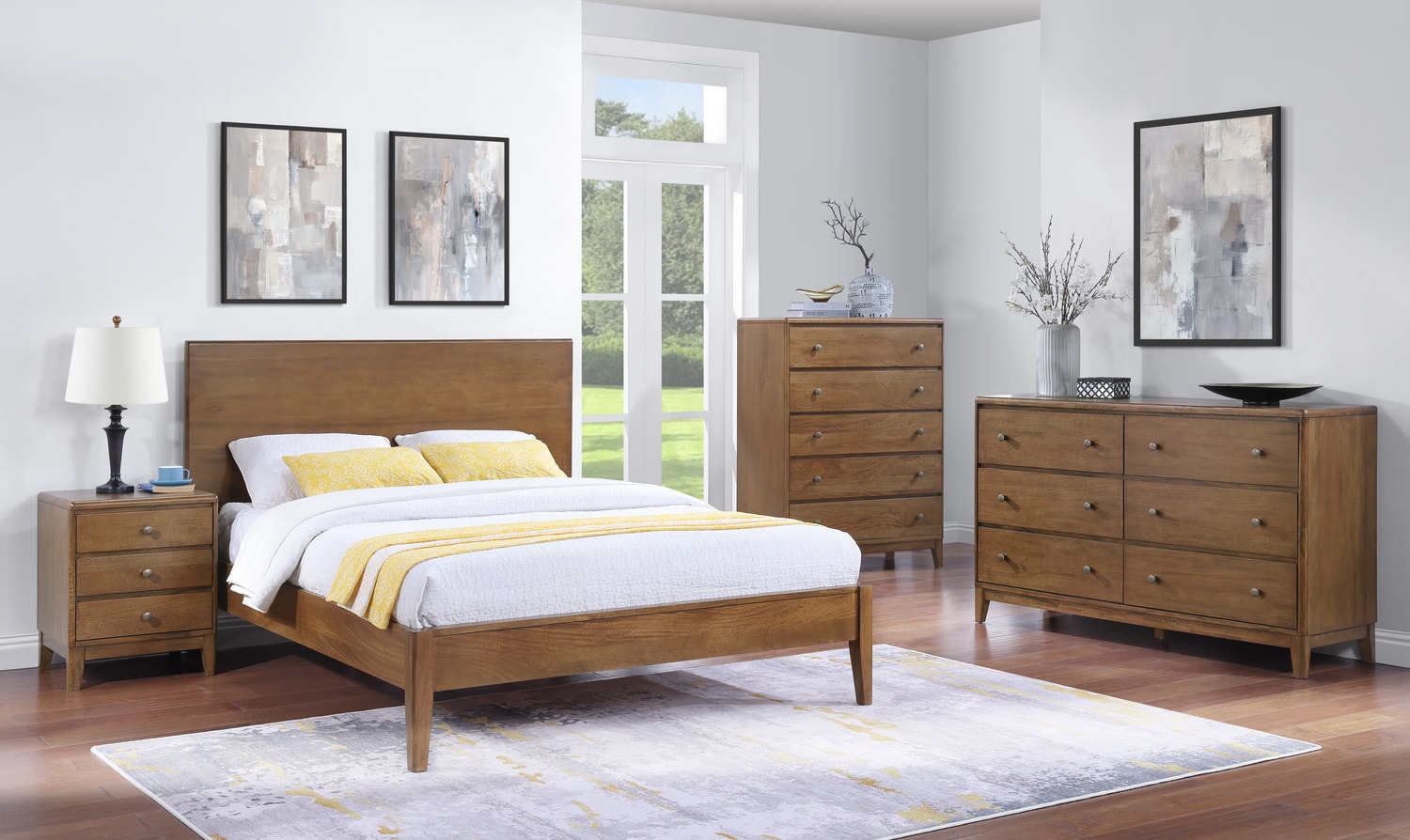 Modern bedroom with a bed, side table, dresser, and chest of drawers, decorated with neutral toned bedding and framed art