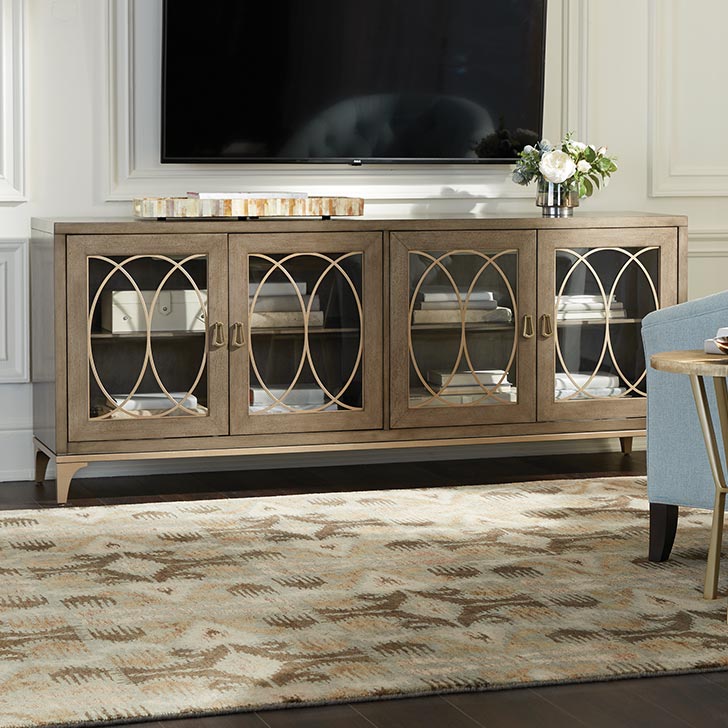 Wooden TV stand with geometric glass doors in a stylish living room