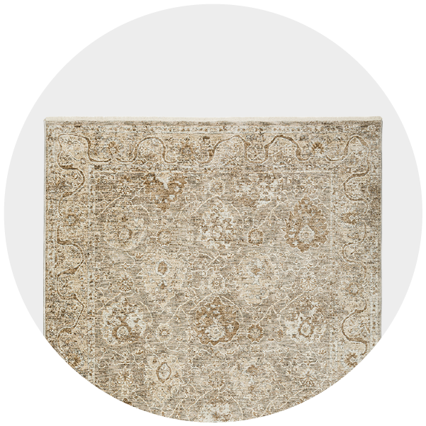 Round image of a beige vintage rug with floral patterns