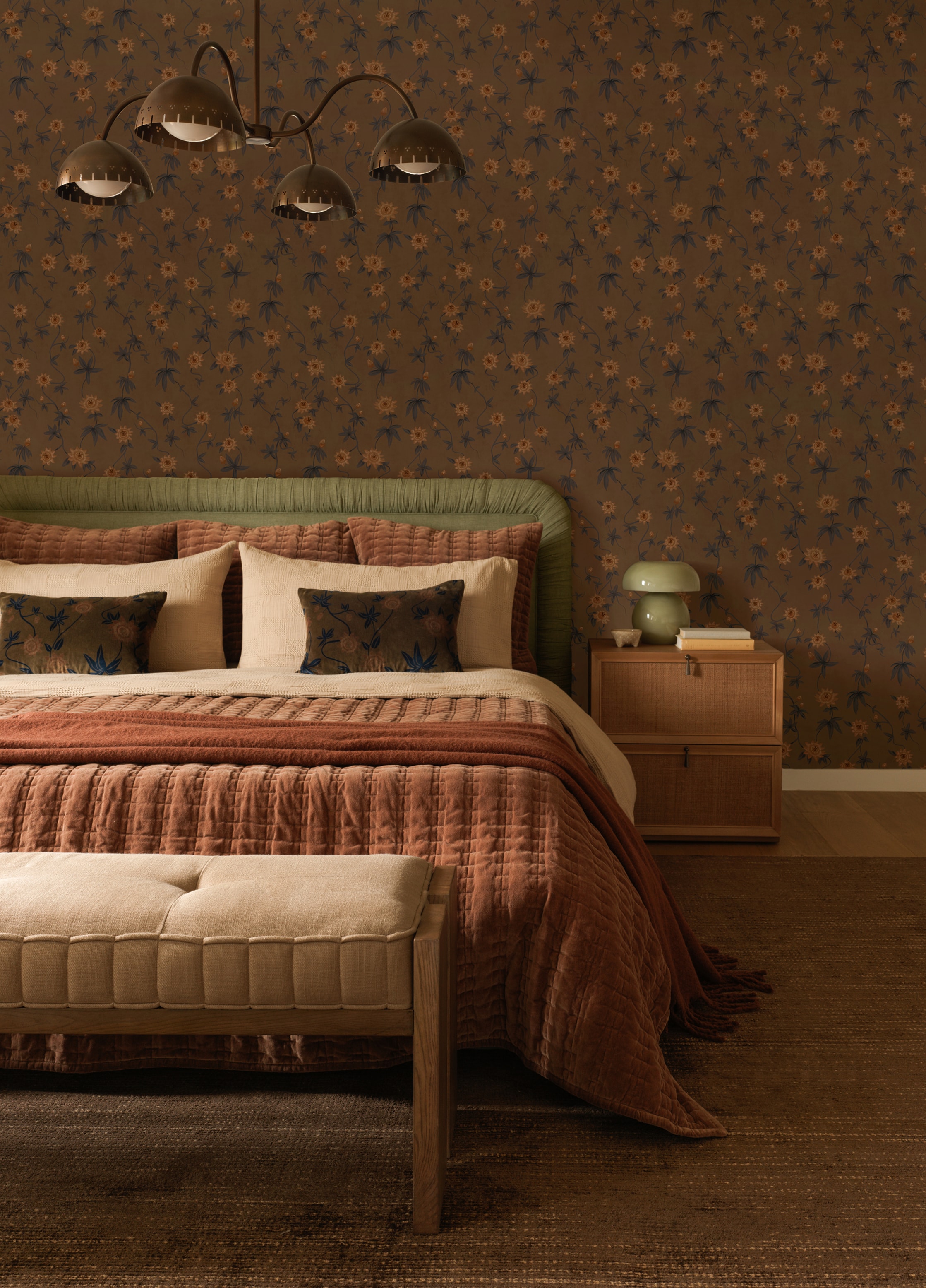 Elegant bedroom with a green bed, floral wallpaper, and a unique overhead lamp