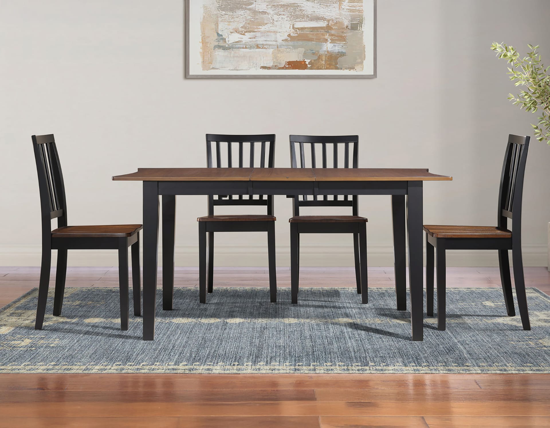 Modern dining set with a dark wood table and four chairs in a room with abstract wall art
