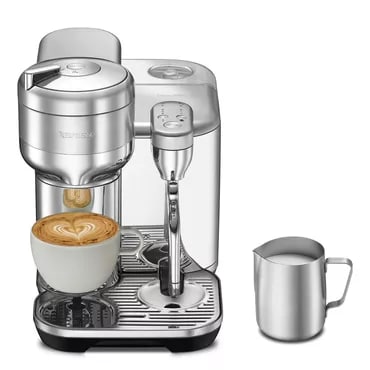 A Nespresso Vertuo coffee machine brewing a cup of coffee with a milk frothing attachment and a mug