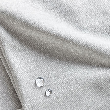 Close-up of water droplets on a gray silk fabric