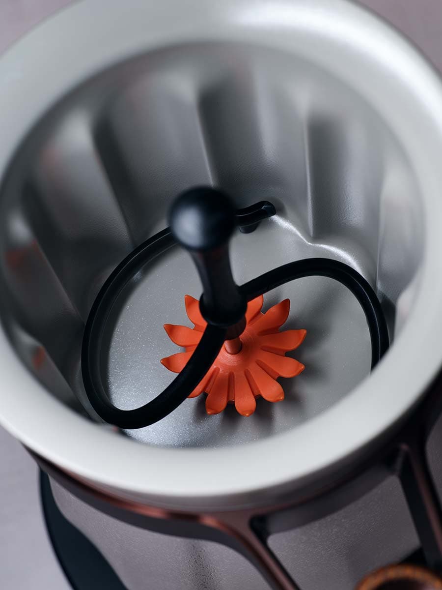 Stethoscope on an orange flower inside a white reflector dish