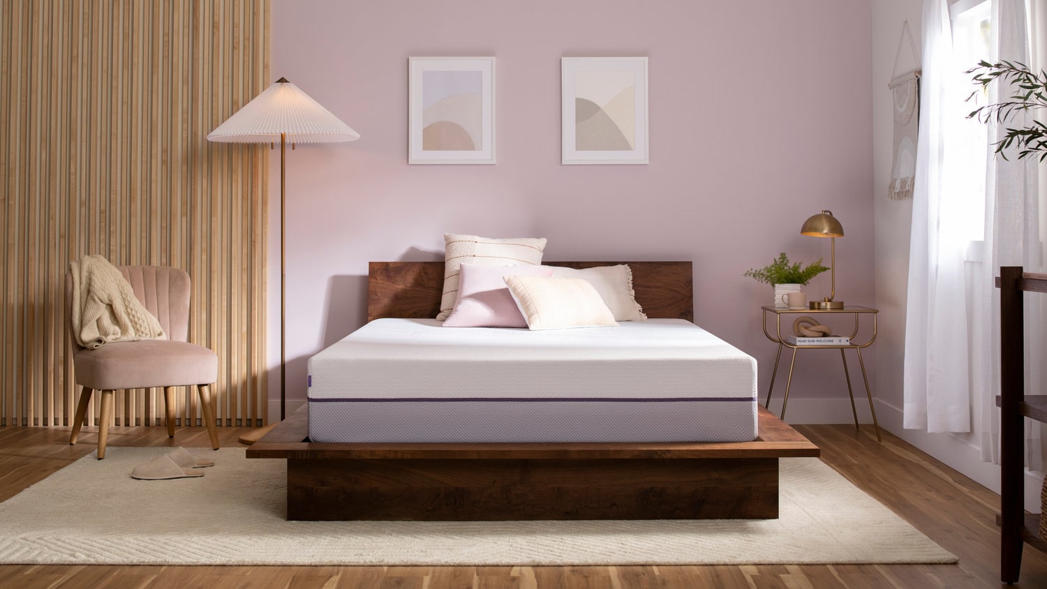 Modern bedroom with a wooden bed, white bedding, pink walls, and minimalist decor