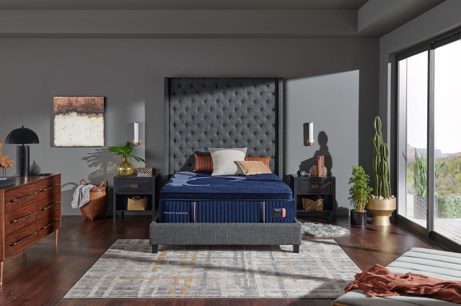 Modern bedroom with a large bed, artistic headboard, floor rug, and balcony access