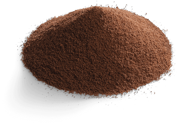 A small mound of fine brown cocoa powder isolated on a black background