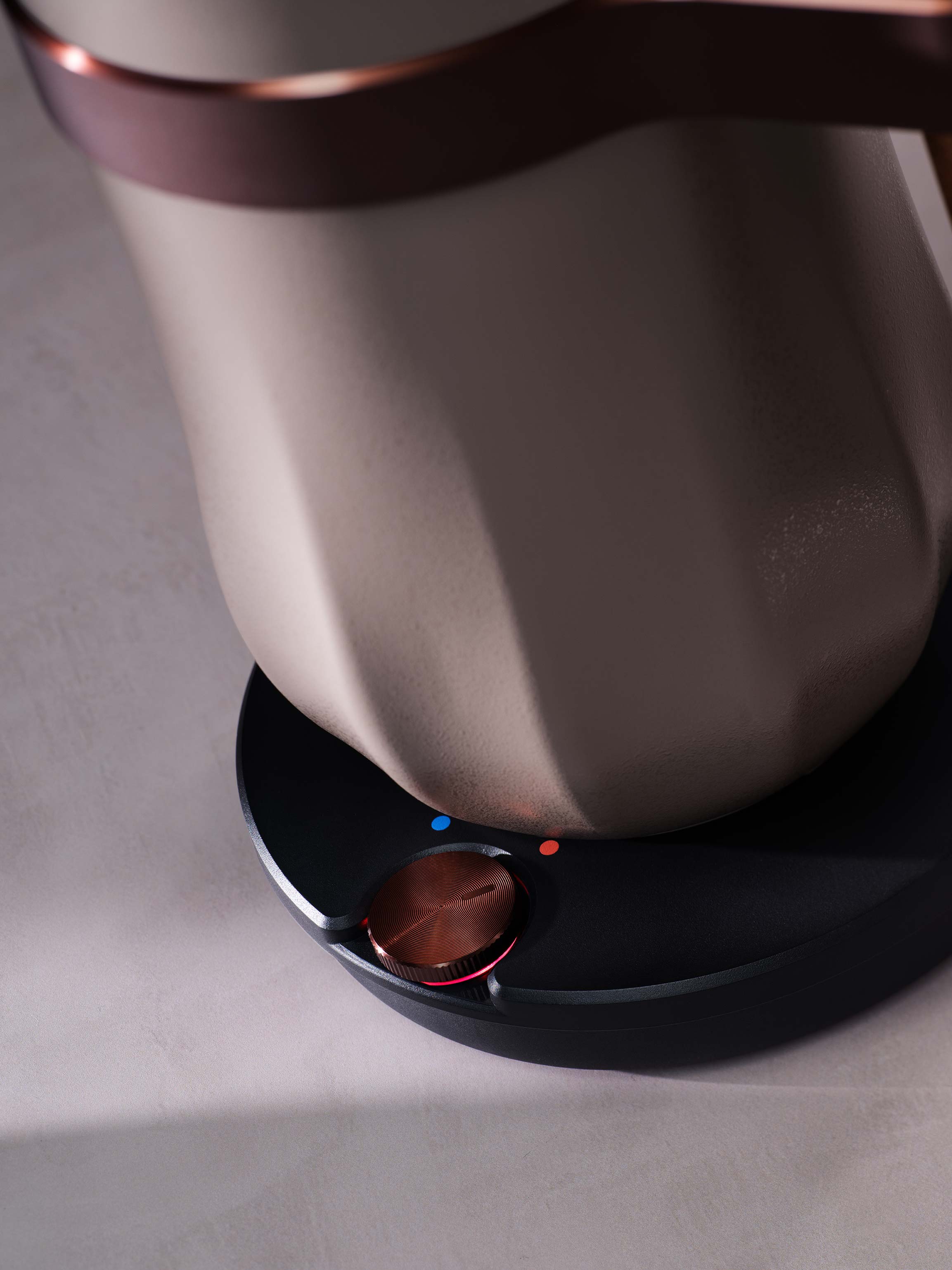 Close-up of a modern kettle on its base with a glowing power indicator light