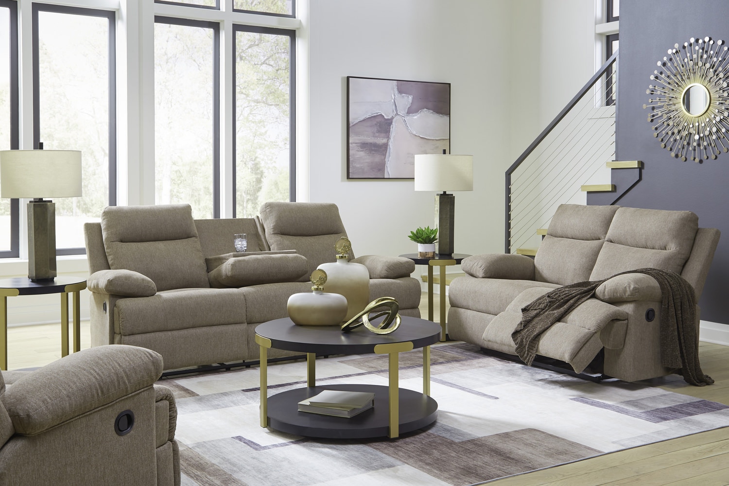 Modern living room with beige reclining sofas, a circular coffee table, lamps, and large windows