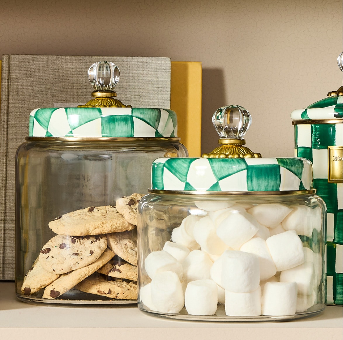 emerald check kitchen canisters filled with sweet treats on a kitchen countertop
