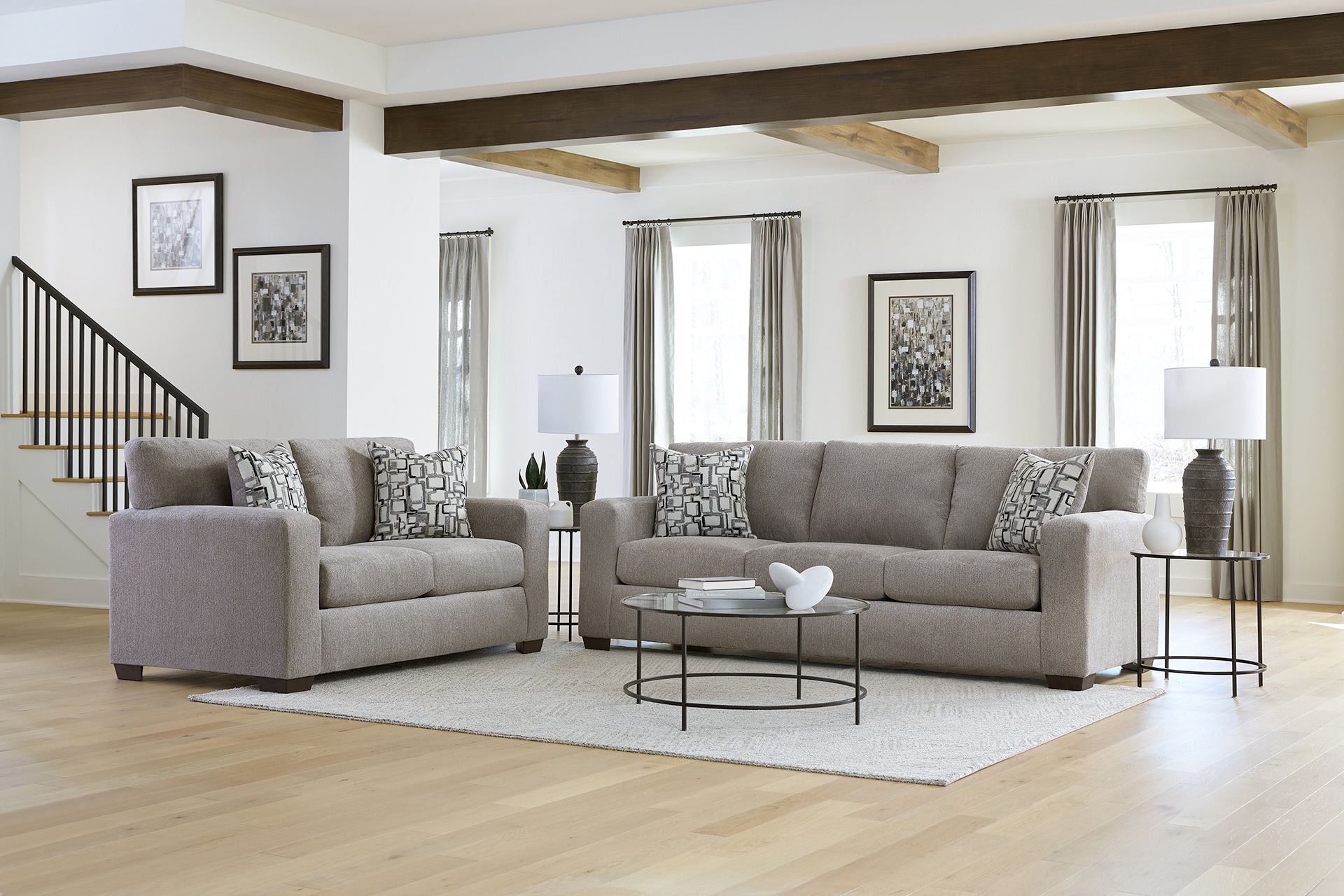 Modern living room with two gray sofas, a coffee table, and a minimalist decor