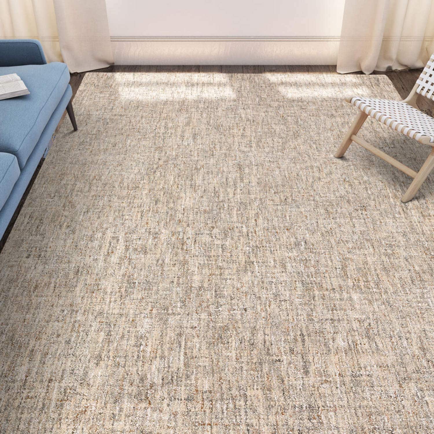 Textured rug in a living room with blue sofa and patterned chair
