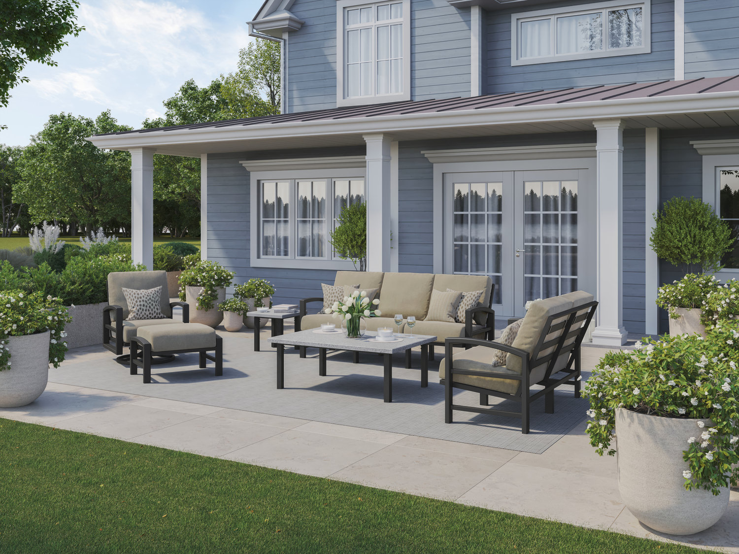 Outdoor patio furniture set outside a gray house with lush greenery