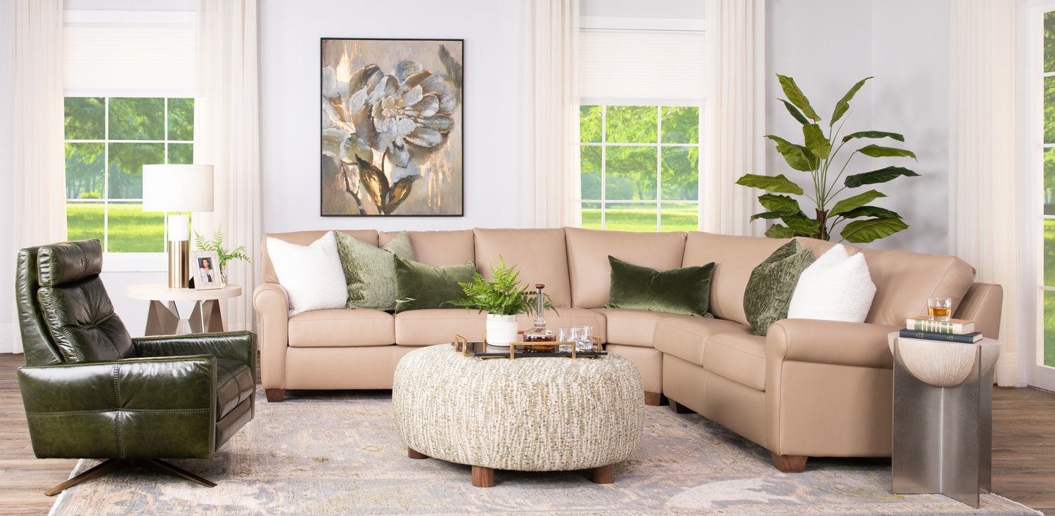 Bright, elegant living room with beige sectional sofa, green recliner, and modern decor