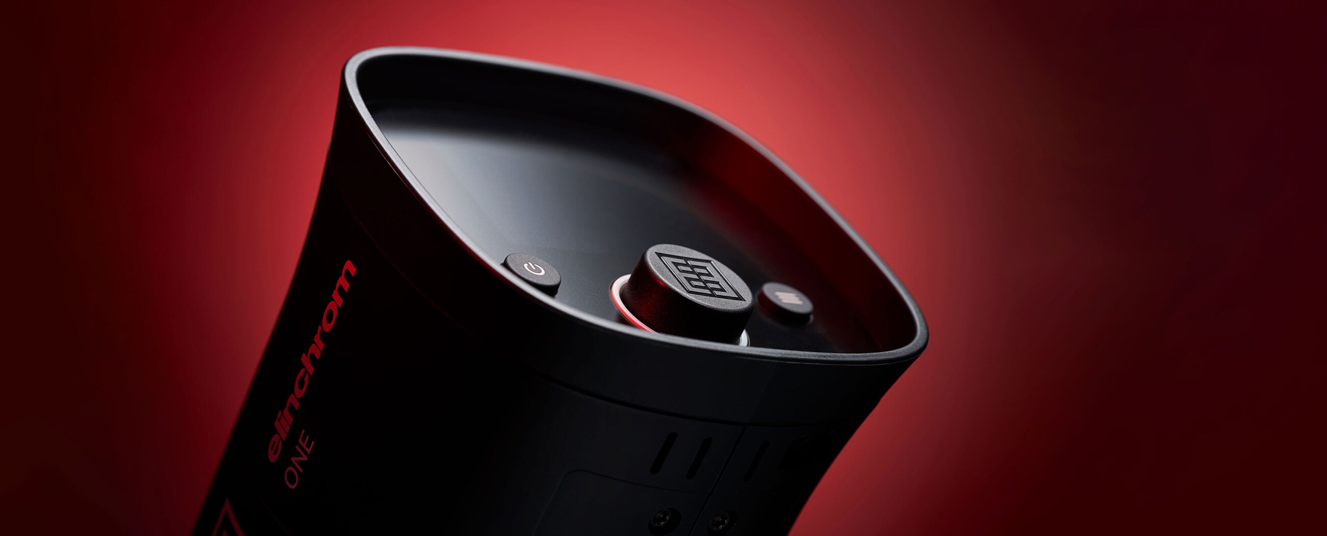 A top-down view of a black coffee cup on a dark red background