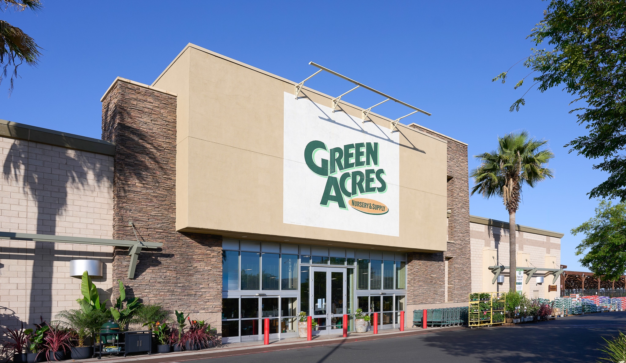 Exterior view of Green Acres nursery store under clear sky