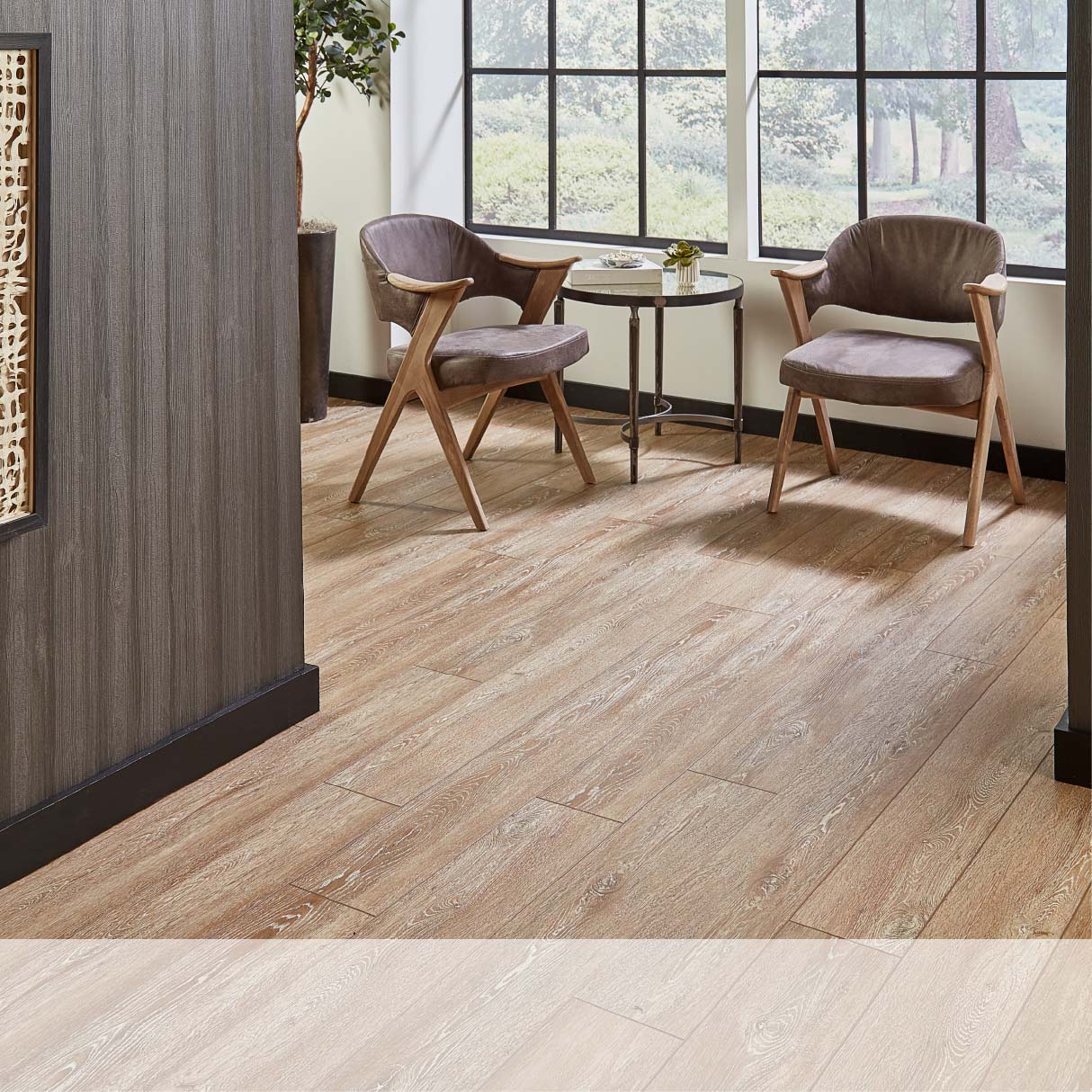 Modern room with two stylish chairs and a small table on a wooden floor near large windows