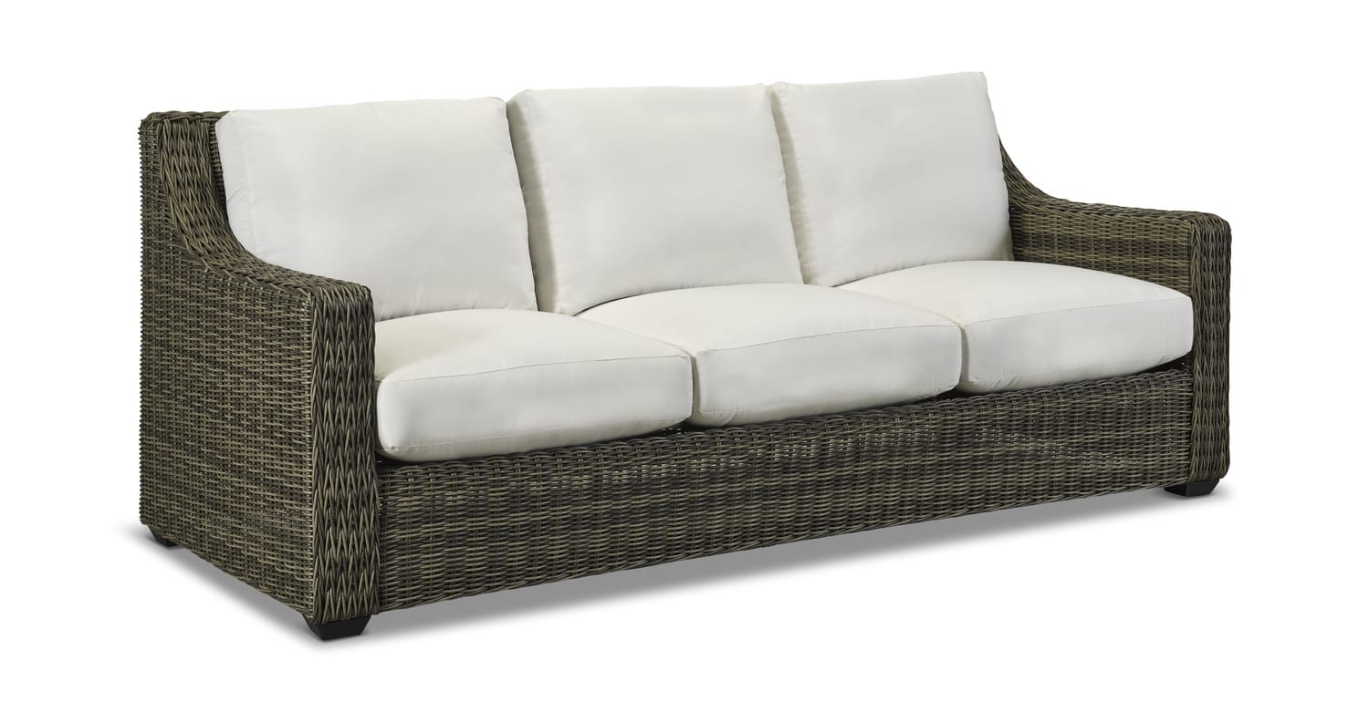 Wicker sofa with white cushions on a white background