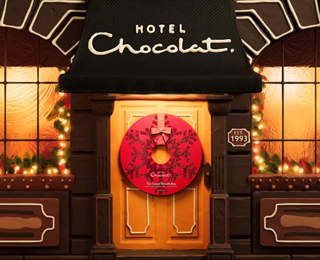 Hotel Chocolat storefront decorated with Christmas wreath and lights