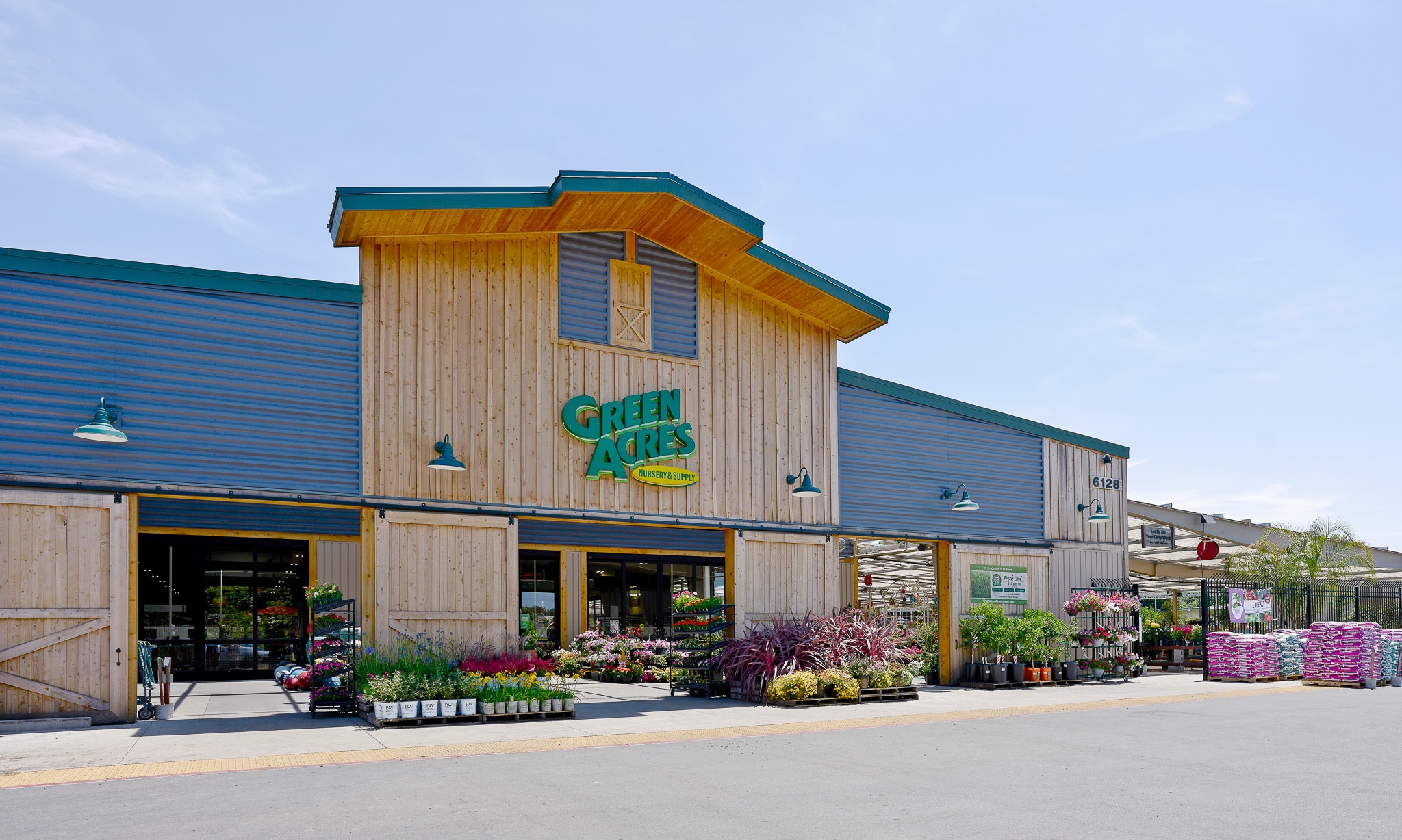 Exterior of a Green Acres Nursery & Supply store with plants displayed outside