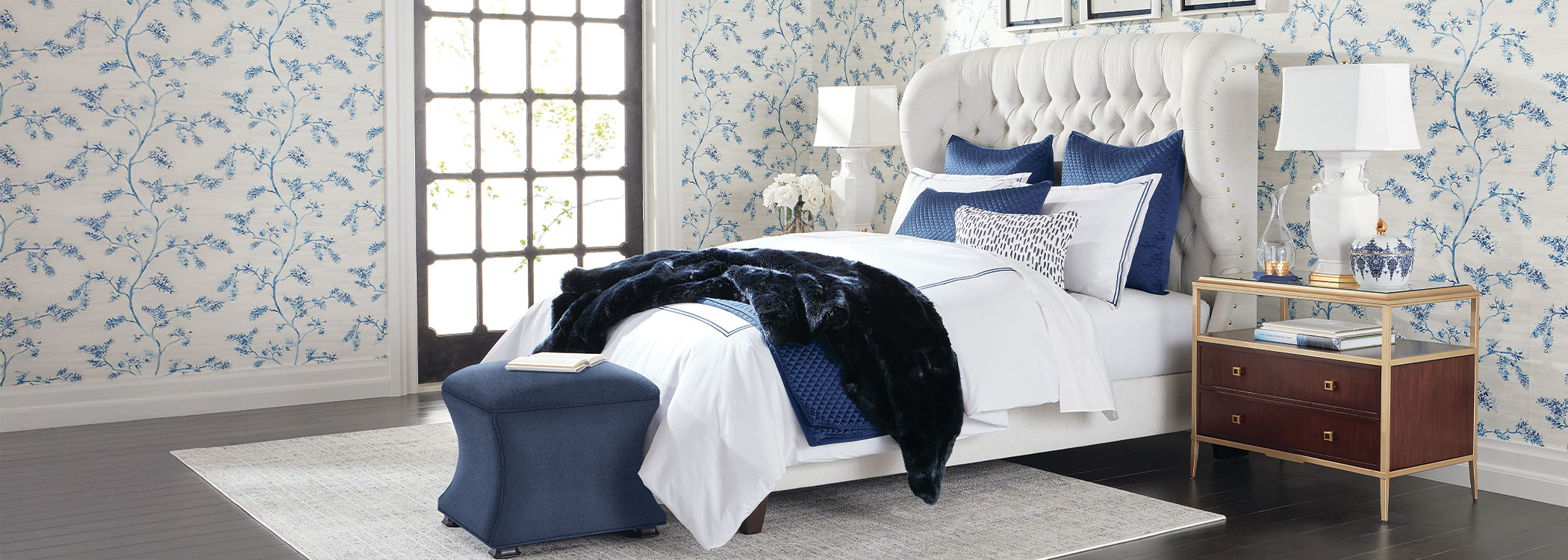 Elegant bedroom with a white bed, blue bedding, and classic decor
