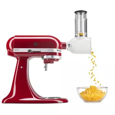 Red stand mixer pouring cooked pasta into a bowl, a kitchen appliance used for food preparation