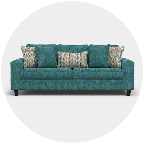 Teal sofa with contrasting patterned cushions on a white backdrop
