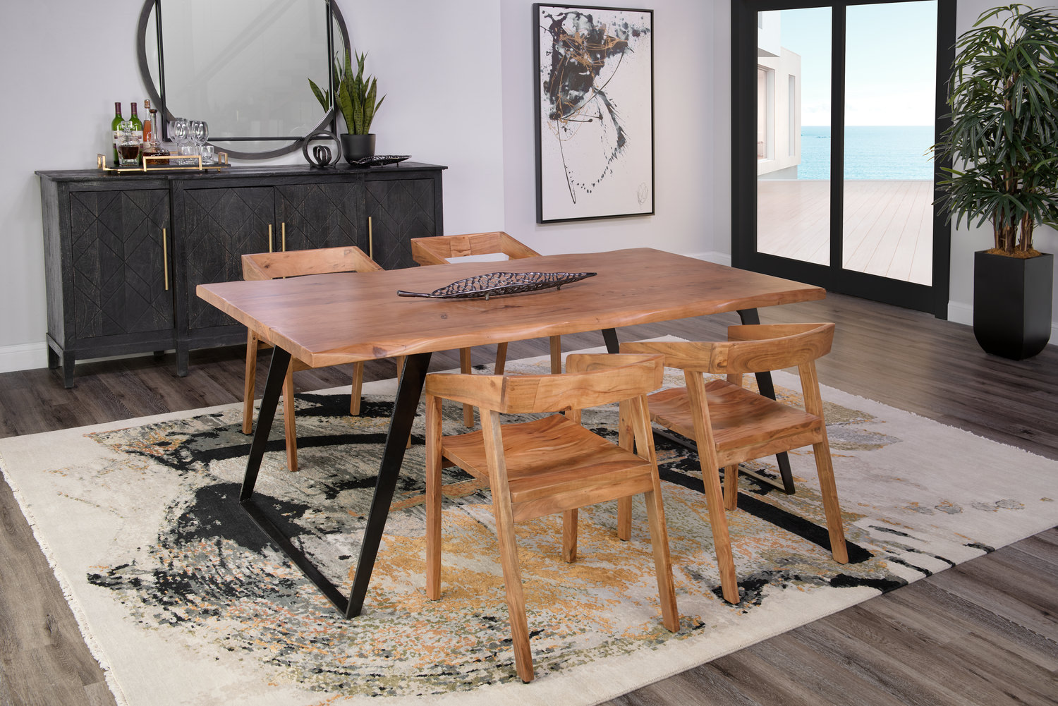 Modern dining room with a wooden table, four chairs, and a beach view through the sliding glass door