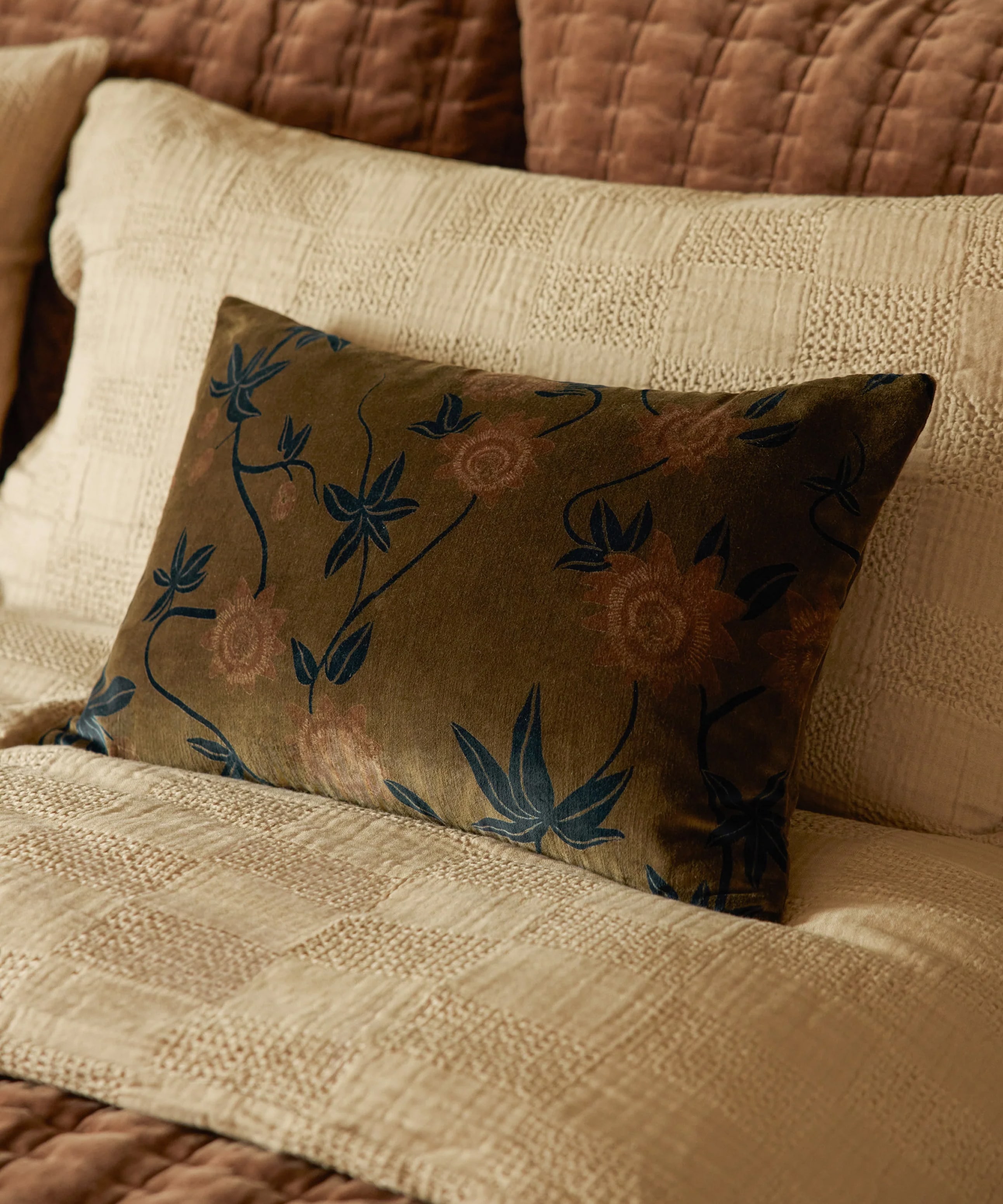 Floral-patterned pillow on a textured beige couch