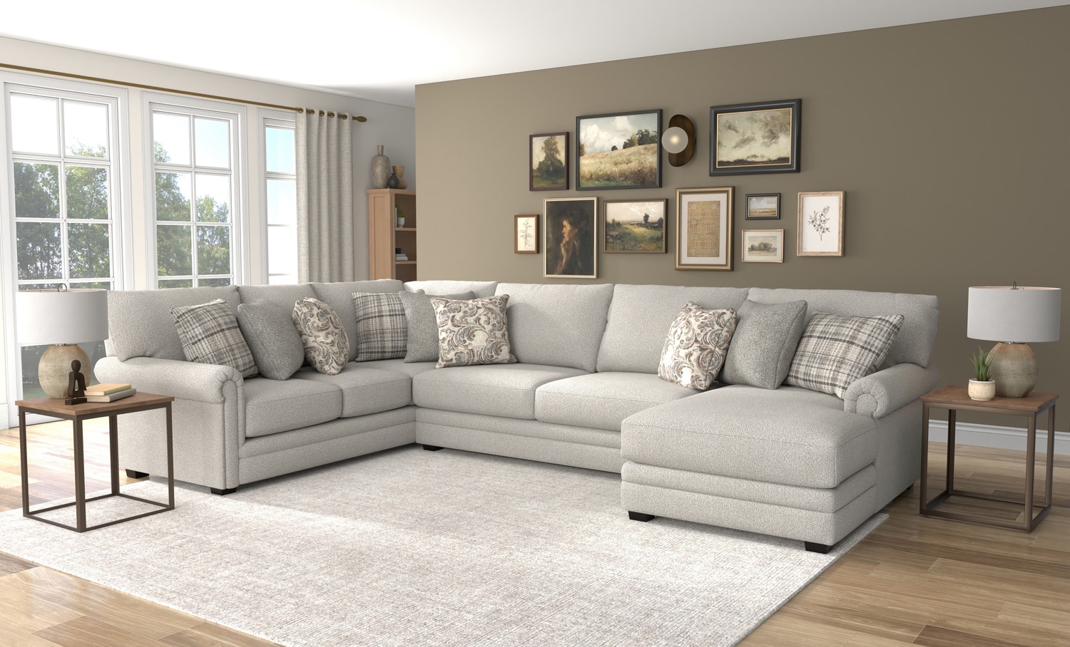 Modern living room with a large beige sectional sofa, gallery wall, and natural light