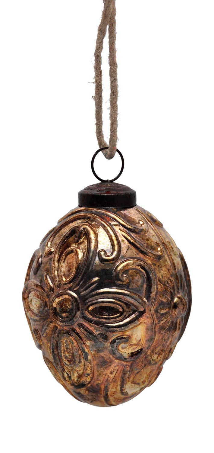 Vintage embossed golden Christmas ornament hanging by a jute string