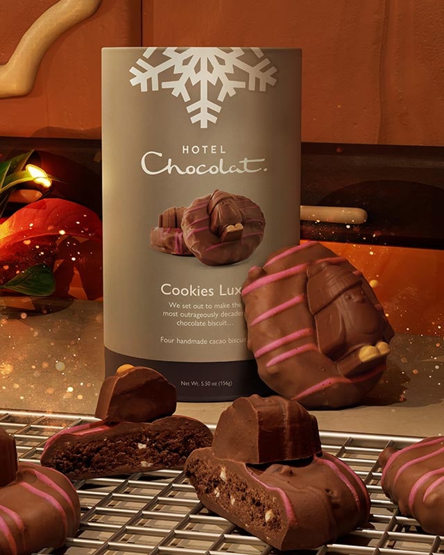 Luxury chocolates on a rack with a "Hotel Chocolat, Cookies Luxe" package in the background