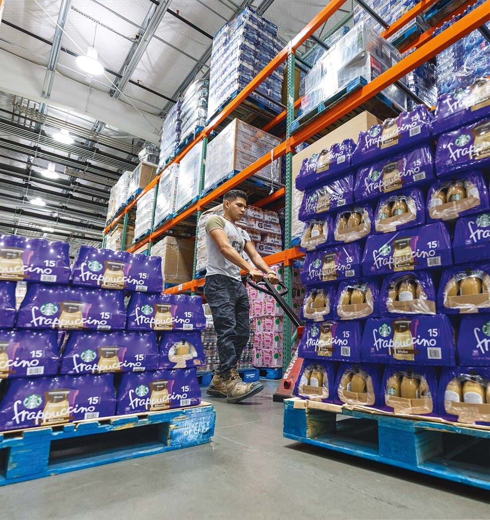 Employee unloading products in a warehouse