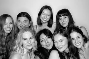 Black and white photo of eight smiling women posing closely together