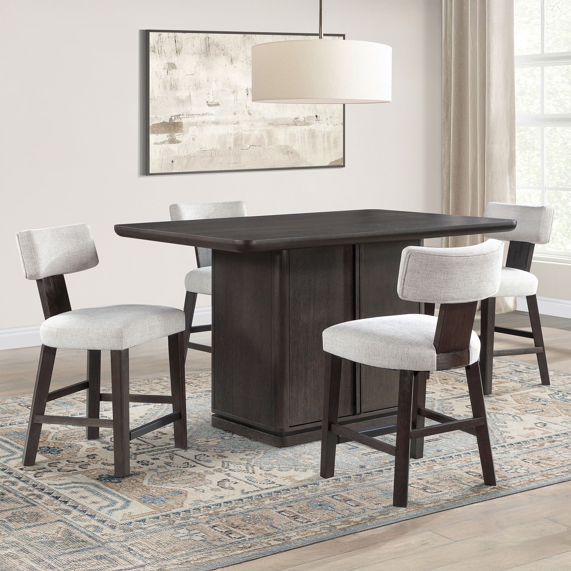 Modern dining set with a dark wooden table and four chairs in a room with a neutral rug and pendant light