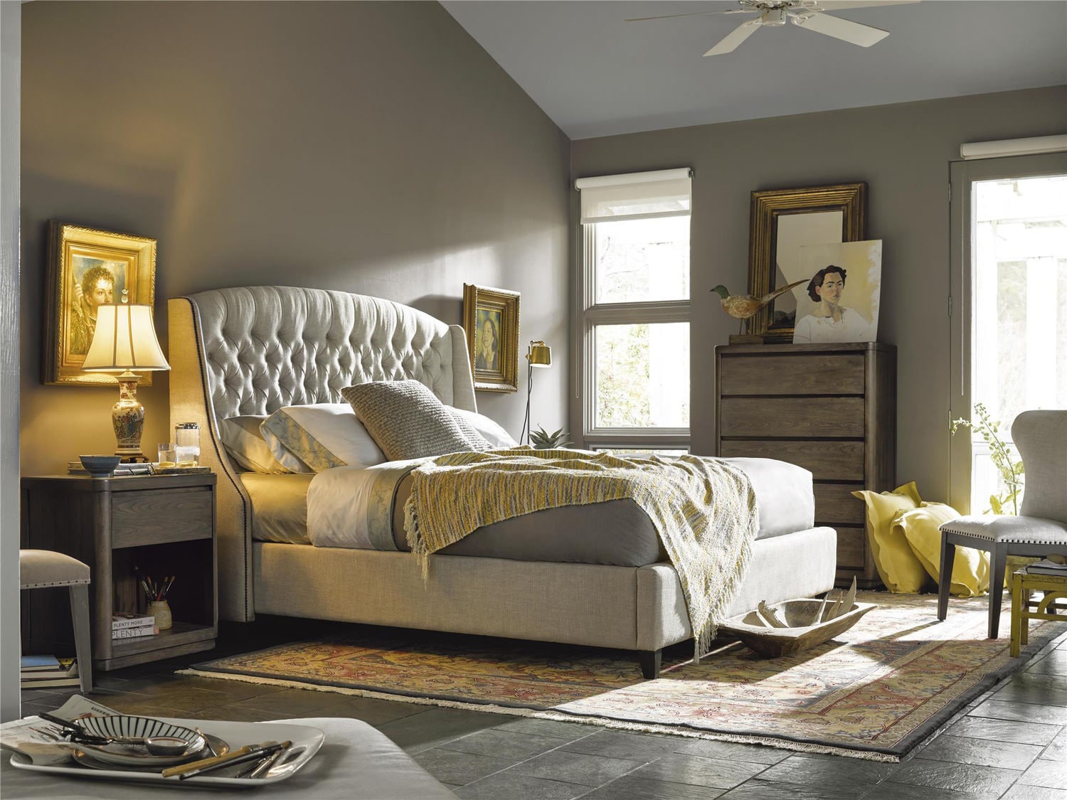 Elegant bedroom with a large tufted bed, matching furniture, and neutral decor
