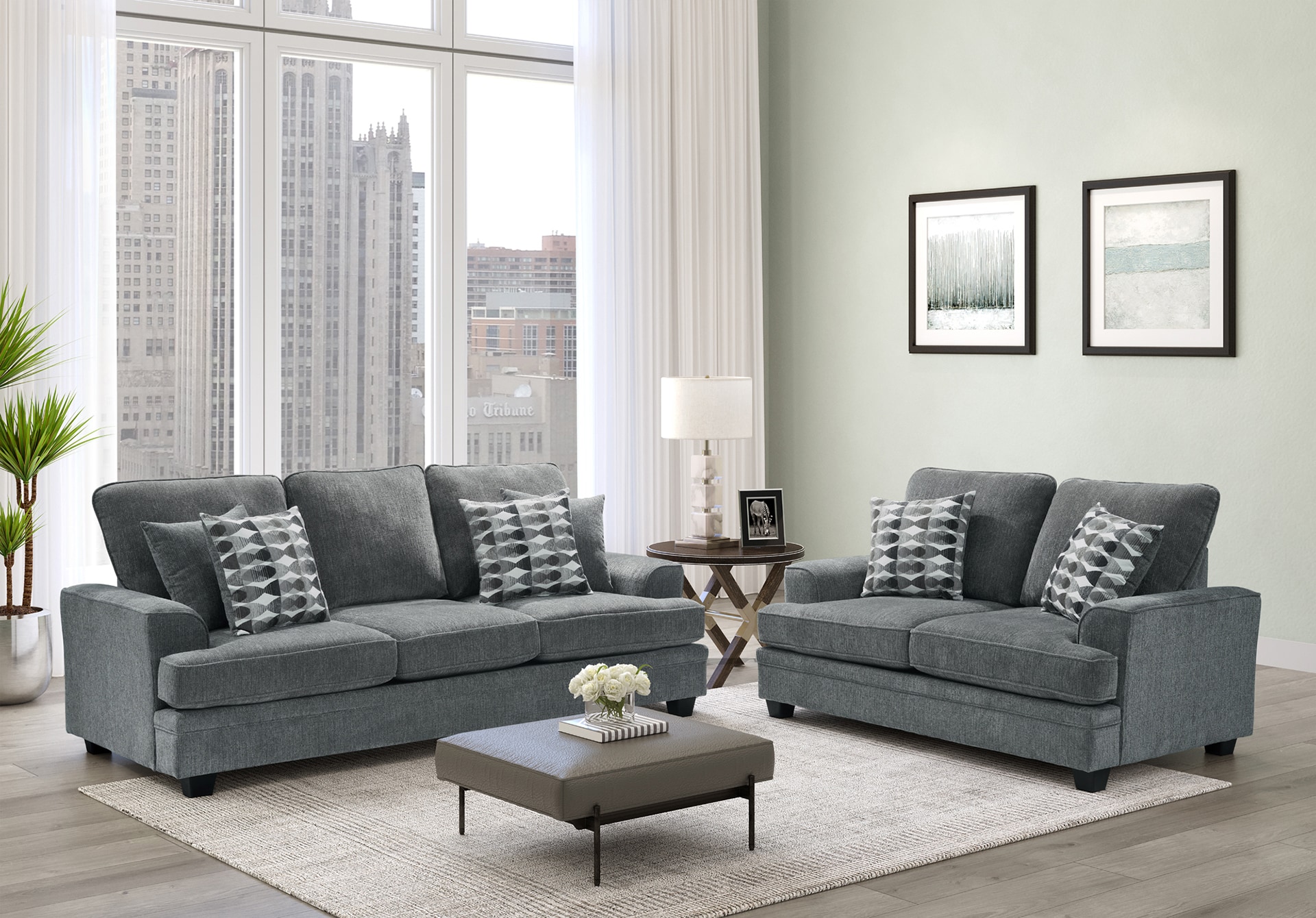 Modern living room with a gray sofa set, coffee table, and city view