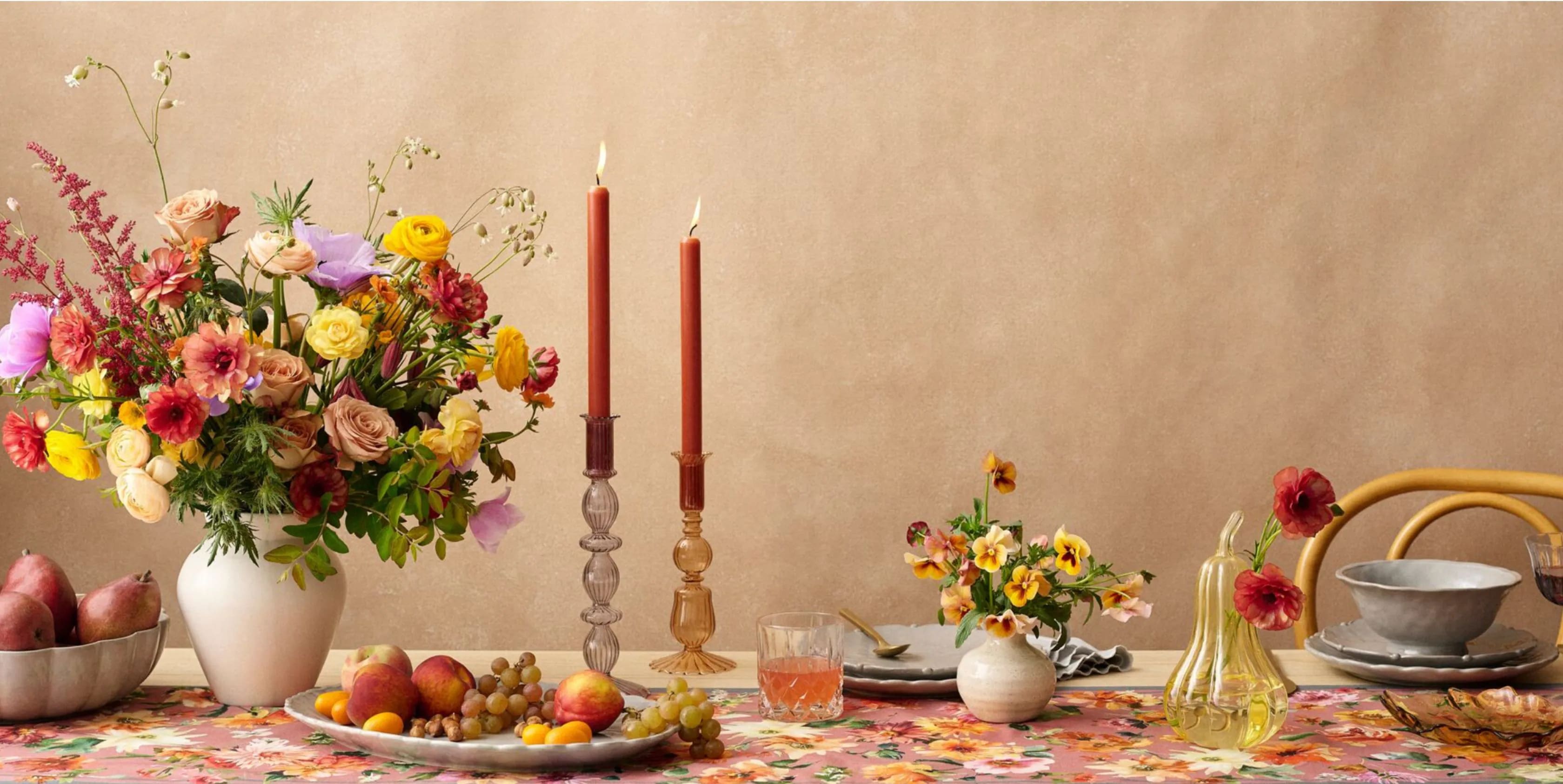 Elegant dining table setting with floral arrangements and candles