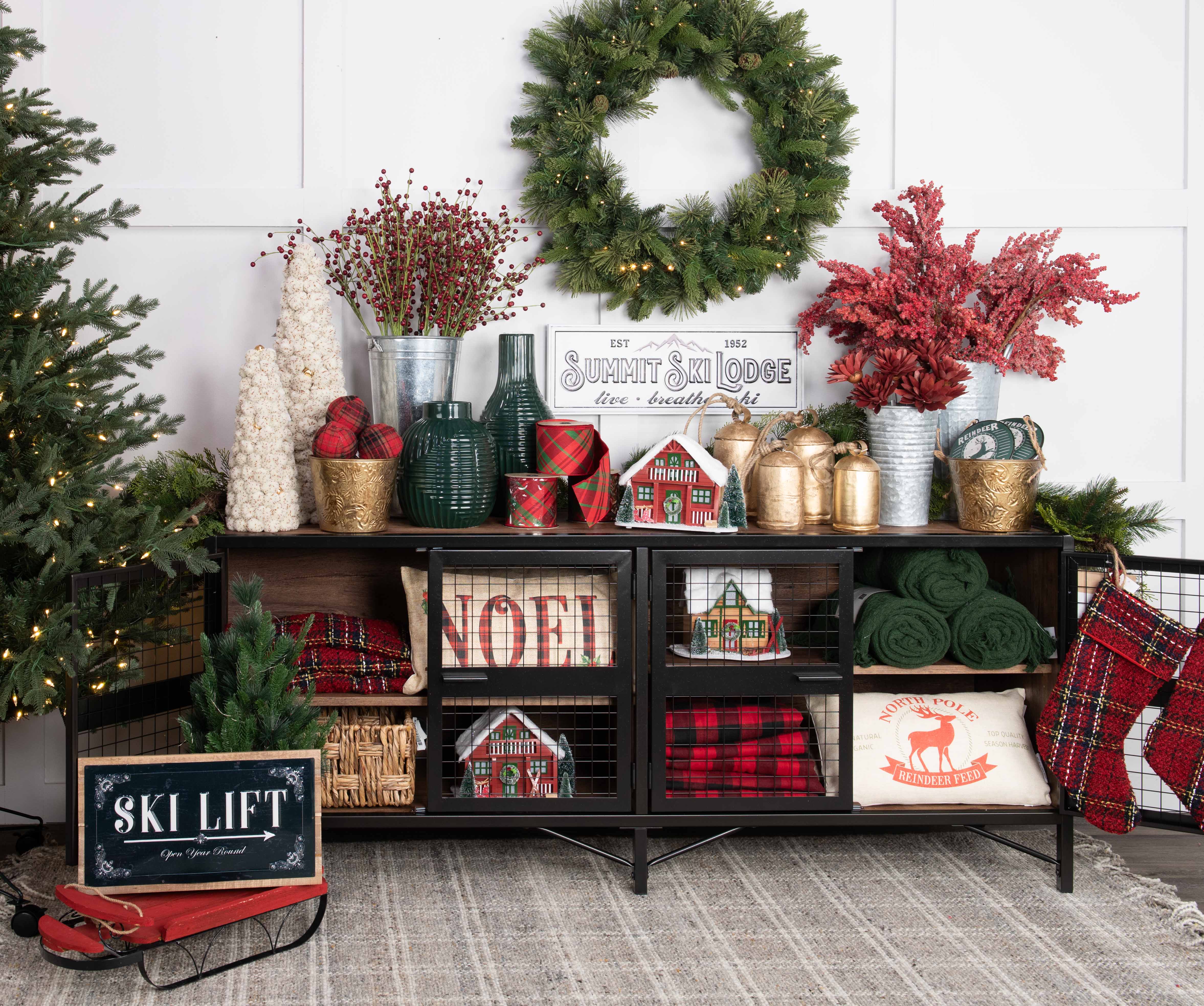 Holiday-themed decor with a wreath, shelf of festive items, and a 'Ski Lift' sled