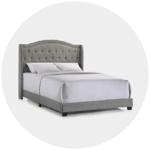 Gray upholstered bed with tufted headboard