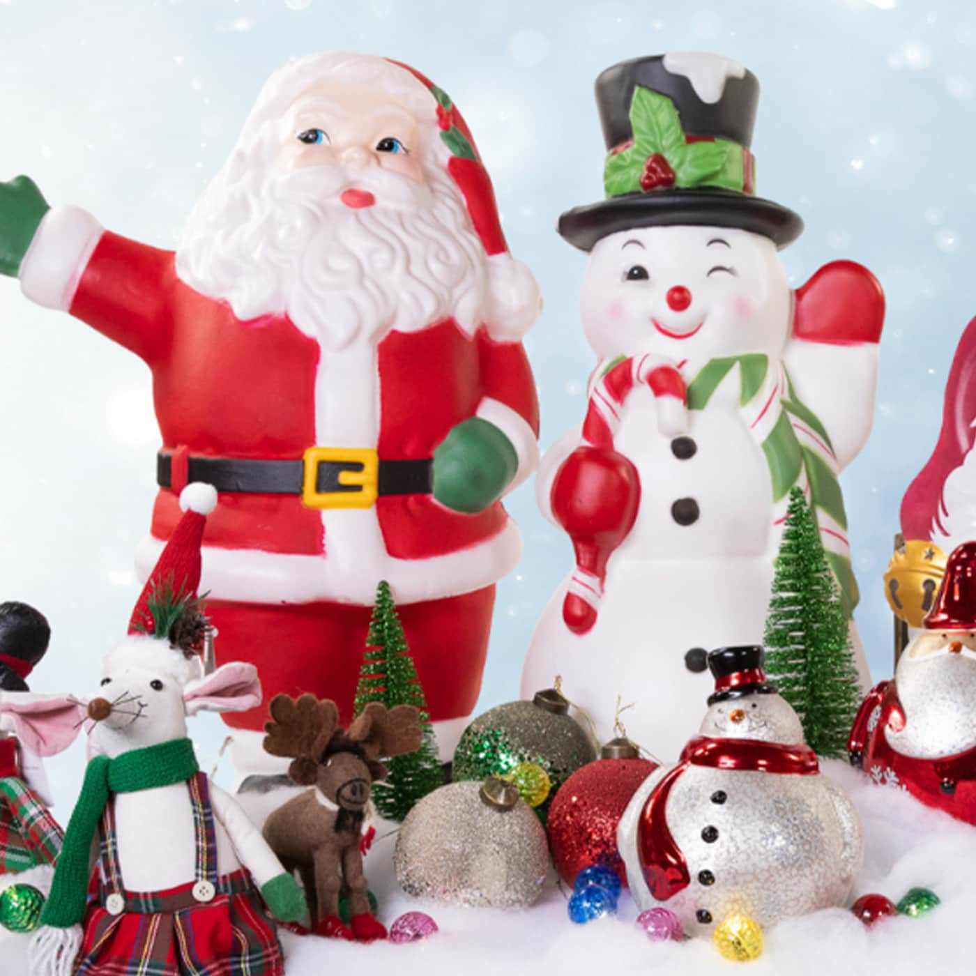 Collection of Christmas figures including Santa Claus, a snowman, and animals in a snowy setting