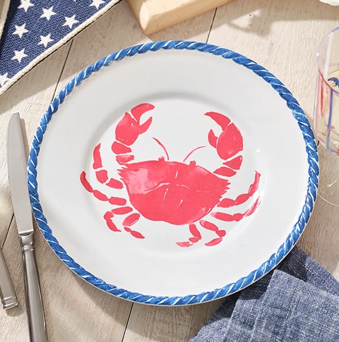 Melamine dinner plate with a red crab design and a blue rim
